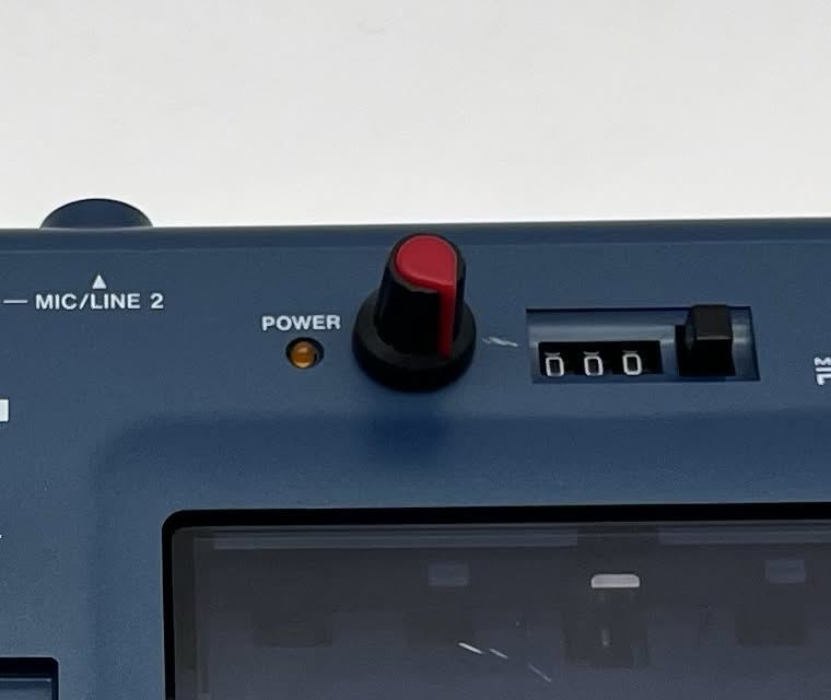 Red-capped pitch control knob next to the power light
