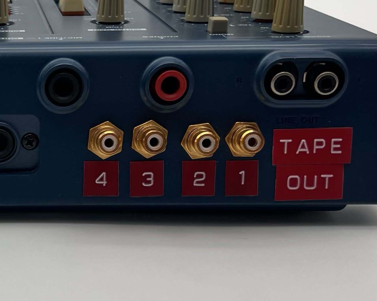 Four gold RCA tape out jacks labeled 1 to 4