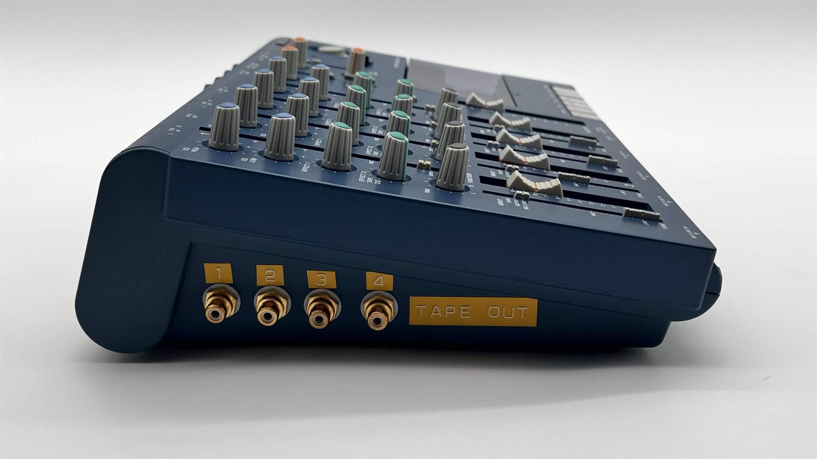 Side of a Tascam Portastudio with four gold-labeled tape outs